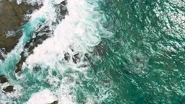 CERRITOS BCS MEXICO-2020: Blue Waves Crash Against Large Dark Rocks Creating