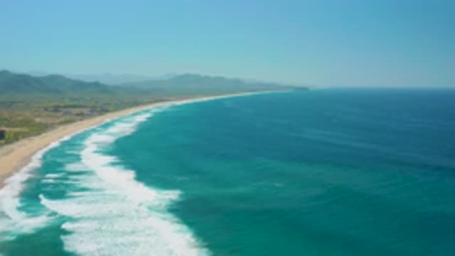 CERRITOS BCS MEXICO-2020: White Waves Crash Against Sandy Shore With Green