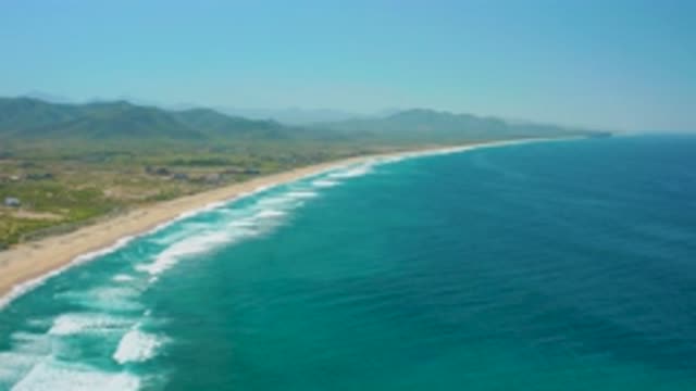 CERRITOS BCS MEXICO-2020: Waves Crash Onto A Sandy Beach That Curves Along A