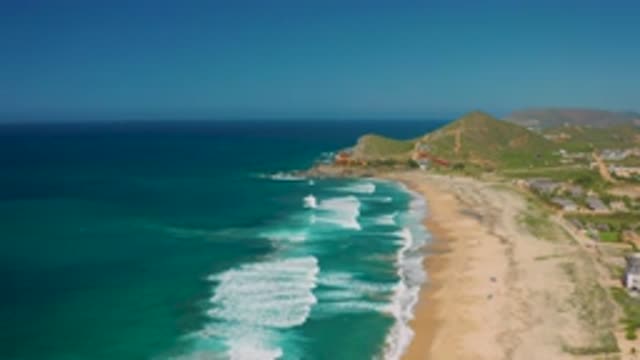 CERRITOS BCS MEXICO-2020: Ocean Waves Crashing On Sandy Shore With Green Hills