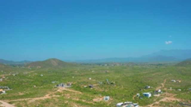 CERRITOS BCS MEXICO-2020: Small Houses Muddy Roads Vast Blue Sky With White Clouds