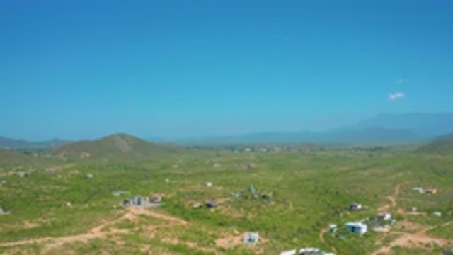 CERRITOS BCS MEXICO-2020: Vast Blue Sky With White Clouds and Small Buildings