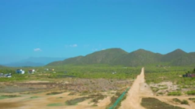 CERRITOS BCS MEXICO-2020: Vast Blue Sky With White Clouds and Muddy Roads Under Tall Mountains