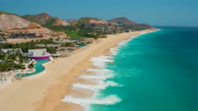 SECRETS MARQUIS LOS CABOS MEXICO-2020: Waves Lapping At The Shore Of A Beautiful Beachside Pool