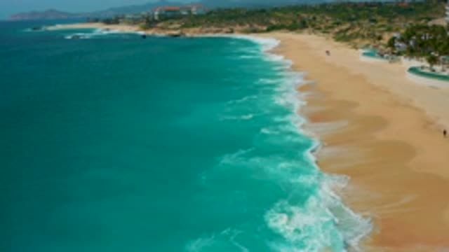 SECRETS MARQUIS LOS CABOS MEXICO-2020: Waves Crashing On Sandy Beach With Lush Greenery