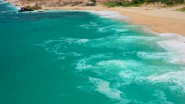SECRETS MARQUIS LOS CABOS MEXICO-2020: Waves Breaking Onto Sandy Beach On Sunny Day