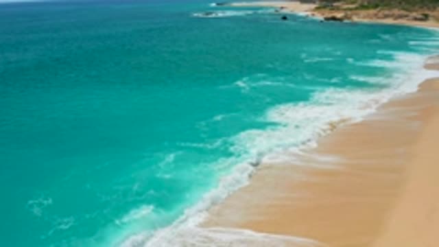 SECRETS MARQUIS LOS CABOS MEXICO-2020: Aerial Footage Of A Sandy Beach Line As Waves Move Back And Forth