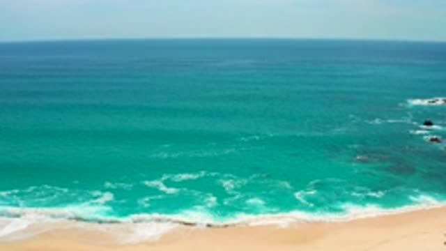 SECRETS MARQUIS LOS CABOS MEXICO-2020: Waves Splashing Onto A Sandy Beach
