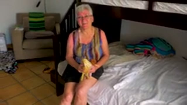 Grandmother Sitting With Child And Dog In Bedroom