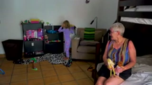 Grandmother Eating Banana While Child Plays