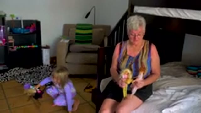 Grandmother And Toddler Playing With Dolls