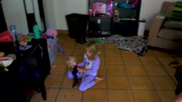 Toddler Girl Playing With Doll On Floor