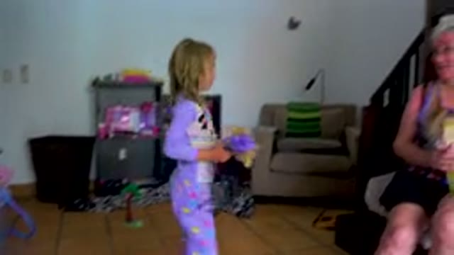 Grandmother And Granddaughter Eating Ice Cream Indoors