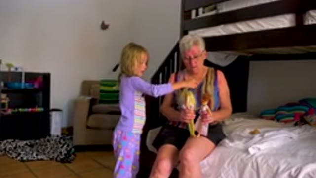 Toddler Feeding Parrot To Grandmother
