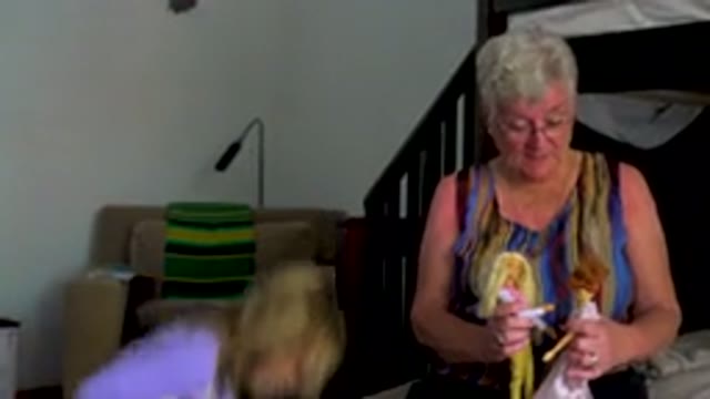 Senior Woman Playing With Dolls And Granddaughter