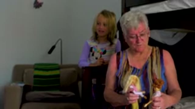 Grandmother Playing With Dolls With Granddaughter