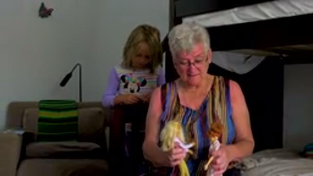 Grandmother Playing With Dolls With Granddaughter