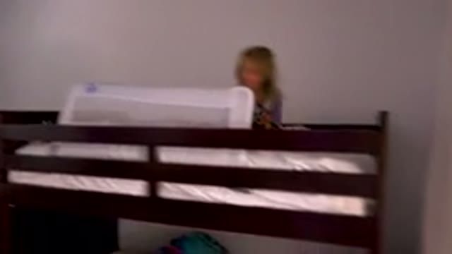 Child Playing On Top Of Bunk Bed