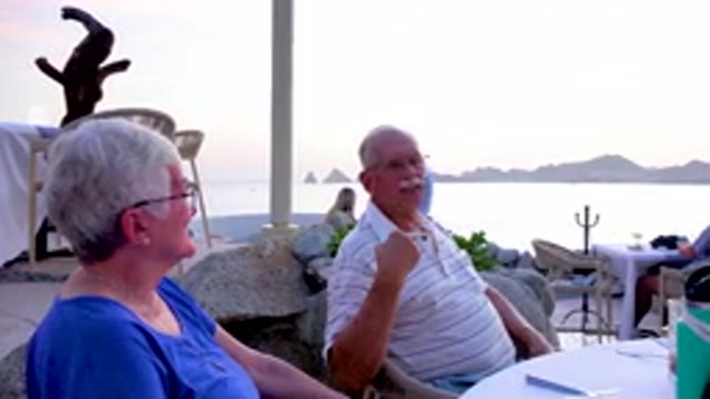 Senior Couple Dining At Beachside Restaurant