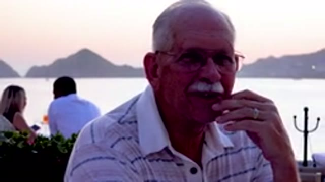 Senior Man Eating Dinner At Beachside Restaurant