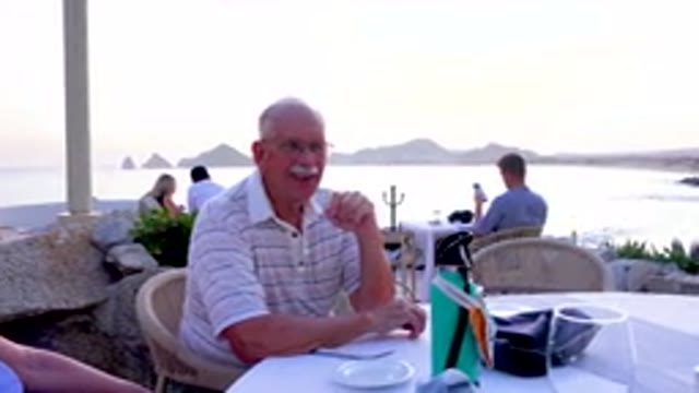 Senior Man Laughing At Outdoor Restaurant
