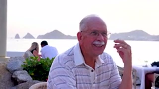 Senior Man Laughing At Outdoor Restaurant