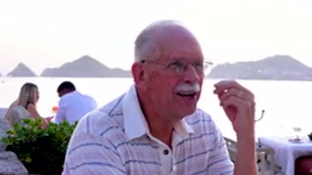 Senior Man Eating At Outdoor Restaurant