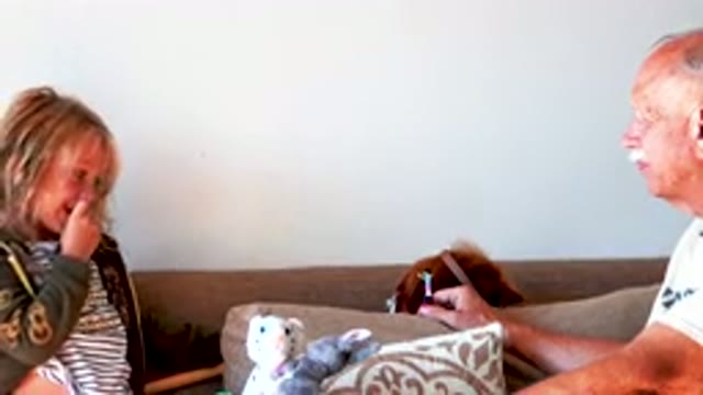 Grandfather and Granddaughter Playing with Stuffed Animals