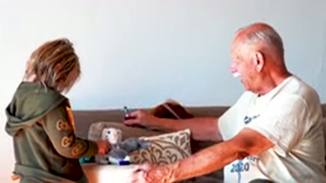 Senior Man And Child Playing With Toys