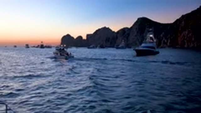 CABO SAN LUCAS MEXICO-2020: Boat Leaving The Harbor At Dusk