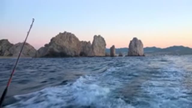 CABO SAN LUCAS MEXICO-2020: Fishing Boats at Sunset Near Cliffside