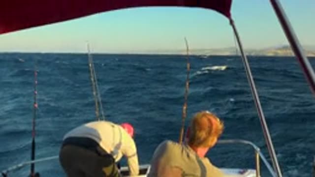 CABO SAN LUCAS MEXICO-2020: Two Men On A Boat In The Choppy Waters Fishing