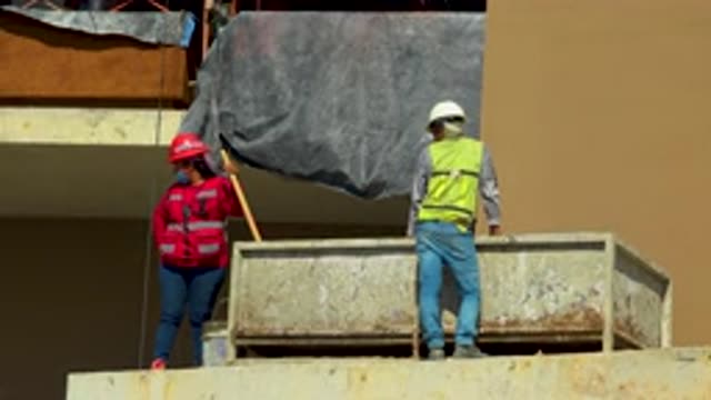 CABO SAN LUCAS MEXICO-2020: Lady Construction Worker Wearing Red Jacket Blue Jeans and Helmet