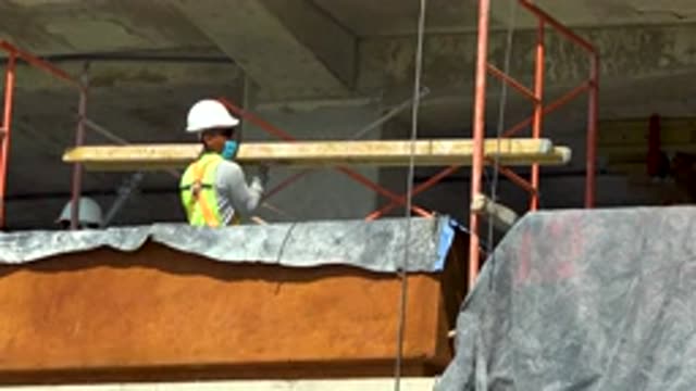 CABO SAN LUCAS MEXICO-2020: Construction Worker Lifting Long Wood Beam