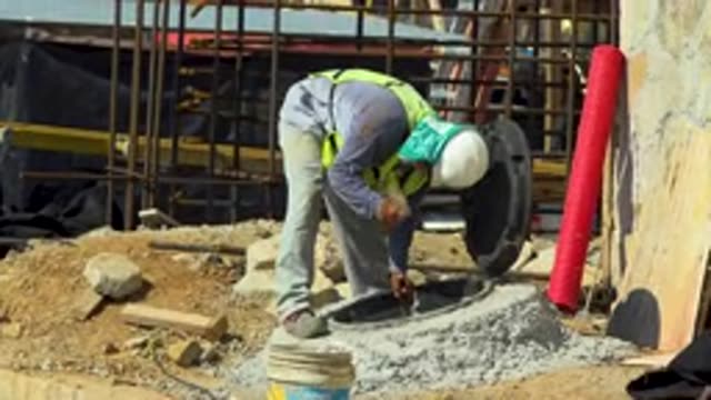 CABO SAN LUCAS MEXICO-2020: Working Concrete Hard Hat Hammer Job Manhole