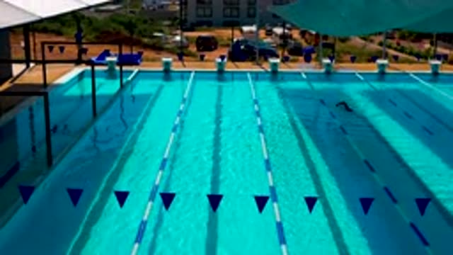 CABO SAN LUCAS MEXICO-2020: Blue Clean Swimming Pool Man Swimming Lastly Flags