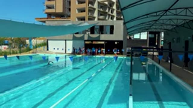 CABO SAN LUCAS MEXICO-2020: Men Swimming in Hotel Sky Blue Pool