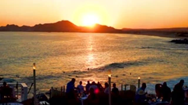 CABO SAN LUCAS MEXICO-2020: Group Of People Watching The Sunset On The Shores Of