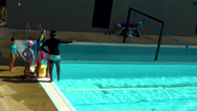 CABO SAN LUCAS MEXICO-2020: Swim Instructor Points Towards Pool And Gives Instructions