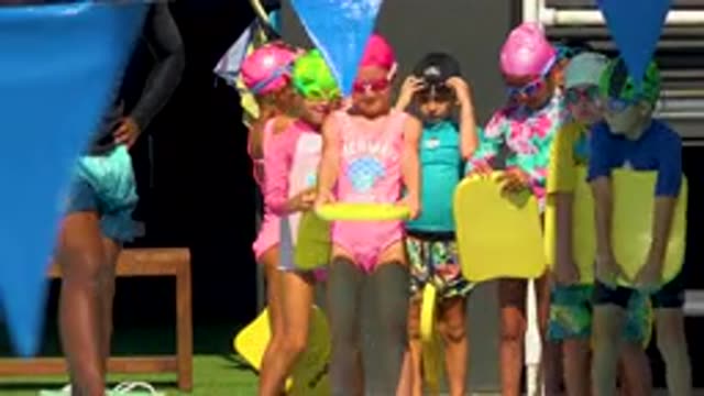CABO SAN LUCAS MEXICO-2020: People Jumping Into Swimming Pool With Colored Floats