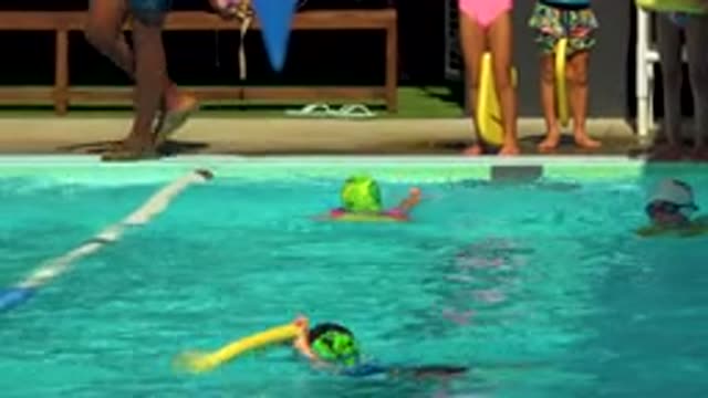 CABO SAN LUCAS MEXICO-2020: Children Wearing Caps Swim In Pool While Adult Stands Nearby