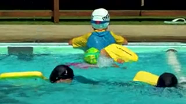 CABO SAN LUCAS MEXICO-2020: Kids Swimming On Yellow Boards In Pool