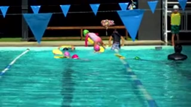 CABO SAN LUCAS MEXICO-2020: Children At Swimming Lessons Doing Laps With Yellow Kickboards
