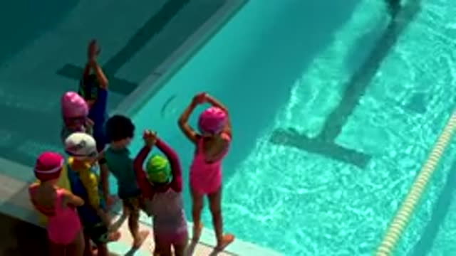 CABO SAN LUCAS MEXICO-2020: Small Children Practicing Diving Into Swimming Pool