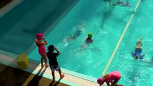 CABO SAN LUCAS MEXICO-2020: Kids Jumping In And Out Of The Pool Swimming Laps