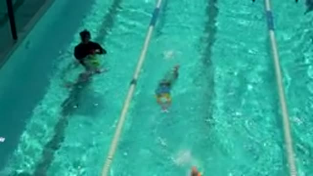 CABO SAN LUCAS MEXICO-2020: Three Children And A Man Swimming In A Large Pool