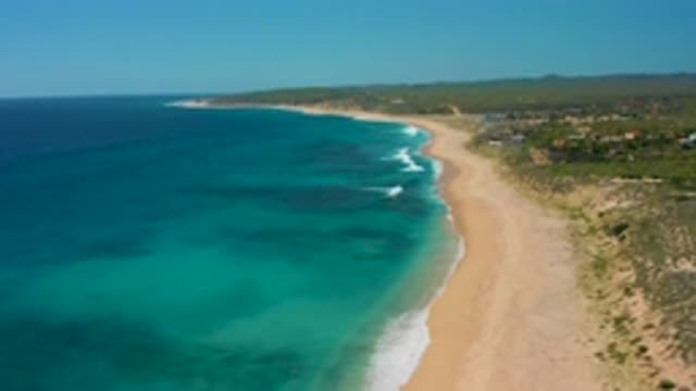 EL CARDONCITO BCS MEXICO-2020: Waves Crash On A Sandy Beach In Daylight That