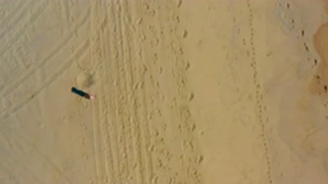 EL CARDONCITO BCS MEXICO-2020: A Person Wearing A Hat Is Making A Bunch Of Footprints In The Sand