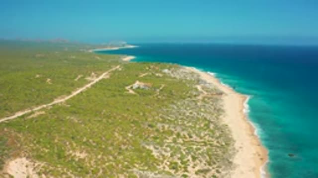 EL CARDONCITO BCS MEXICO-2020: Aerial Video of Calm Blue Ocean With Waves on a Sandy Beach