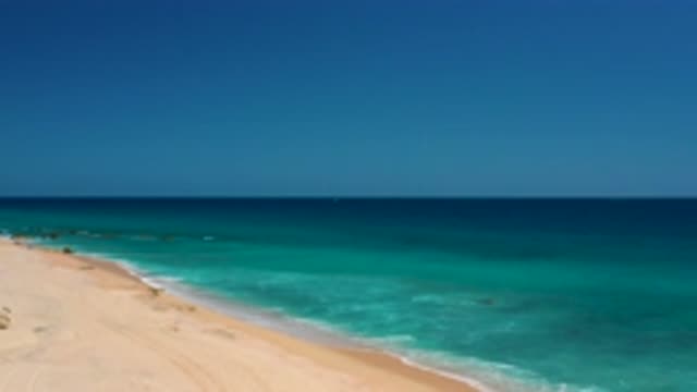EL CARDONCITO BCS MEXICO-2020: Panning Up Over Sandy Beach And Open Deep Blue